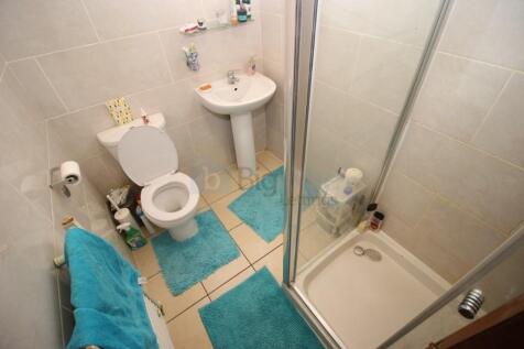 A well-maintained bathroom suite featuring a sh...