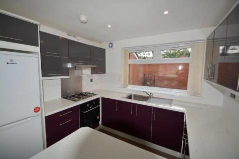 A modern kitchen featuring sleek cabinetry with...