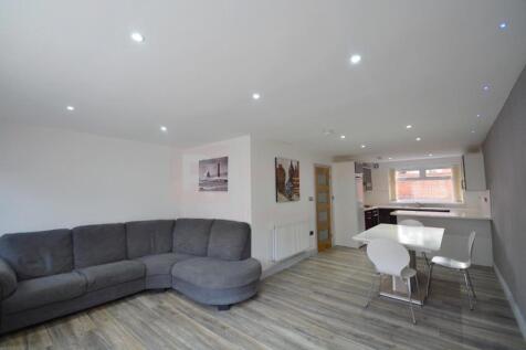 A modern living room with a spacious gray secti...