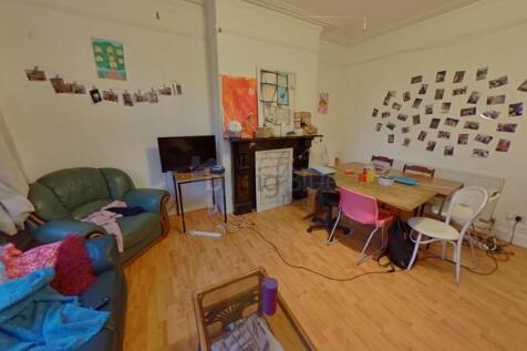 A warm and inviting living room featuring woode...
