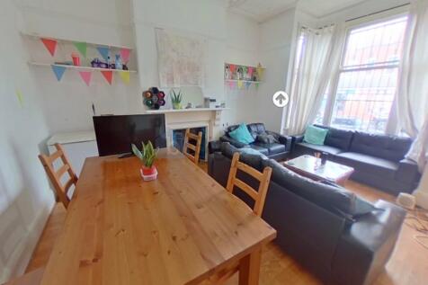 A bright and inviting living room featuring lar...