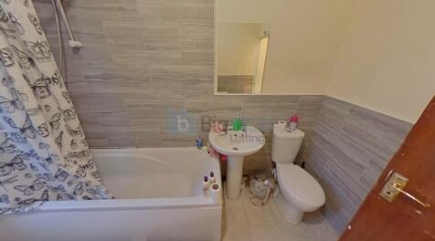A neat and functional bathroom suite featuring ...