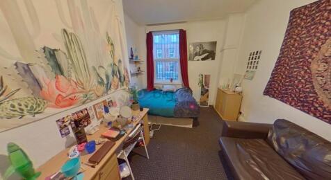 Cozy single bedroom featuring a comfortable bed...