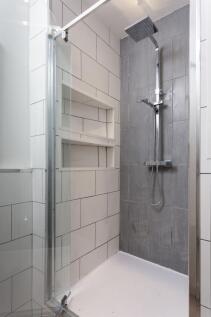 Modern shower area featuring sleek, large gray ...