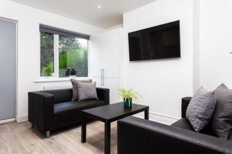 A stylish and contemporary living room featurin...