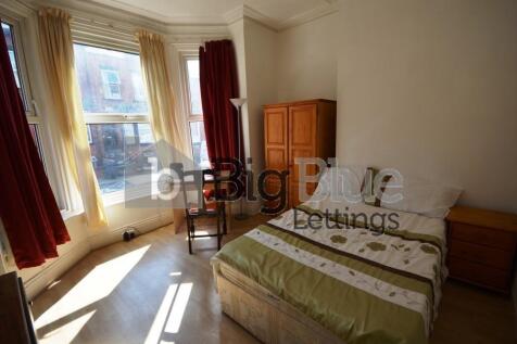 Bright and inviting double bedroom with a large...