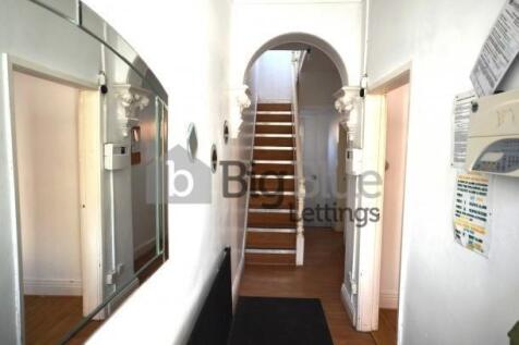 Bright and tidy hallway featuring a clean woode...