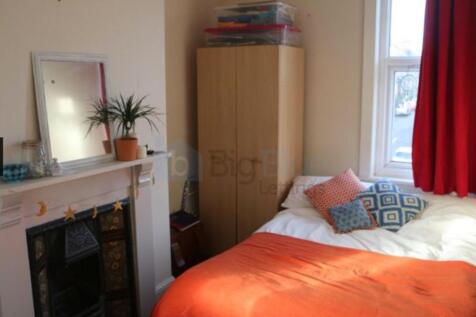A cozy bedroom featuring a comfortable bed with...