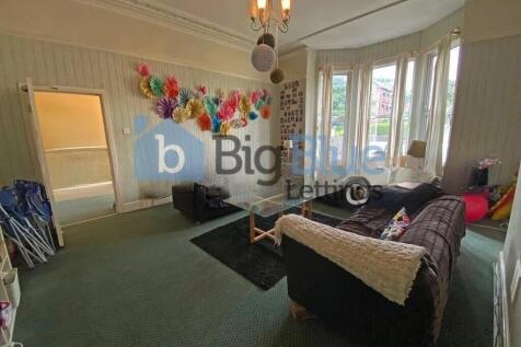 A spacious and inviting living room featuring a...