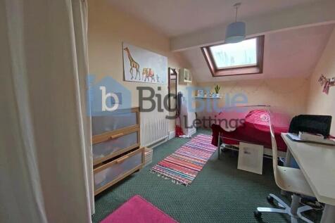 Cozy single bedroom featuring a skylight window...