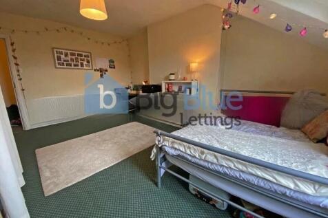 A cozy single bedroom featuring a comfortable s...