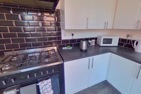 Bright and modern kitchen featuring sleek black...