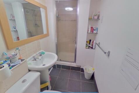 A clean and functional bathroom featuring a wal...