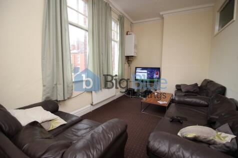 Cozy living room featuring comfortable dark lea...