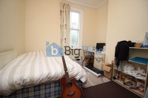 Cozy single bedroom featuring a comfortable bed...