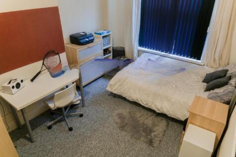 Cozy single bedroom featuring a comfortable bed...