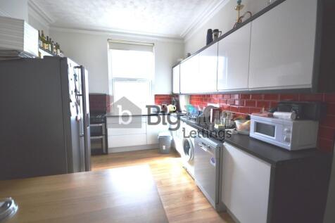 Bright and modern kitchen featuring sleek cabin...