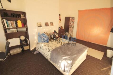 Cozy single bedroom featuring a comfortable bed...
