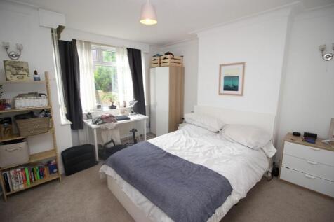 A bright and welcoming double bedroom featuring...
