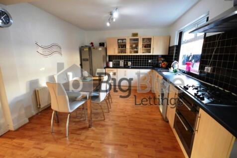 A bright and modern kitchen featuring ample cou...