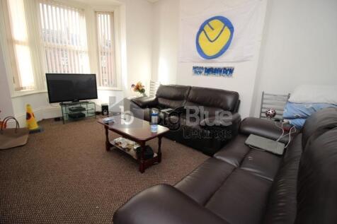 A comfortable living room featuring dark leathe...