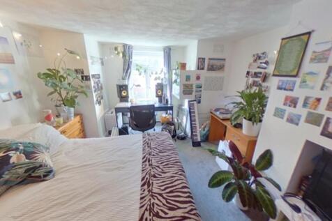 Bright and spacious master bedroom featuring a ...