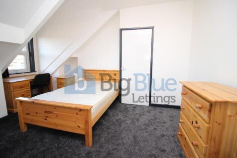 A bright and tidy double bedroom featuring a wo...