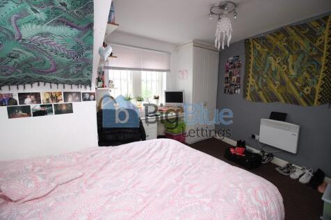 Cozy double bedroom featuring a comfortable bed...