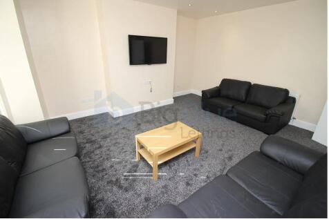 A spacious communal lounge featuring three blac...