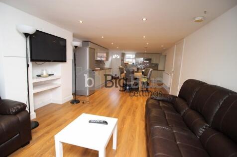A modern and spacious living room with comforta...