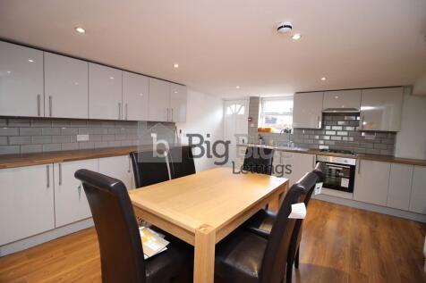 Bright and modern kitchen featuring sleek cabin...