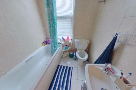 Bright and clean bathroom featuring a full-size...