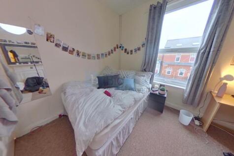 Cozy single bedroom with a comfortable bed, a s...