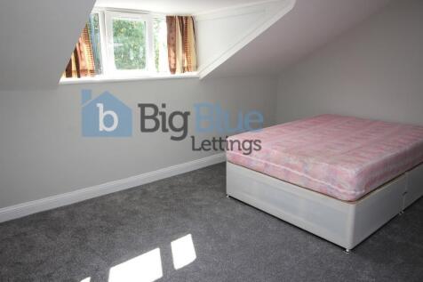 Bright single bedroom featuring a large window ...