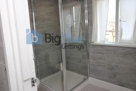 A modern bathroom suite featuring a spacious gl...