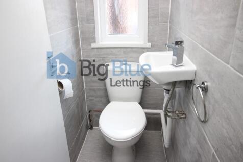 Compact and clean single toilet room with moder...