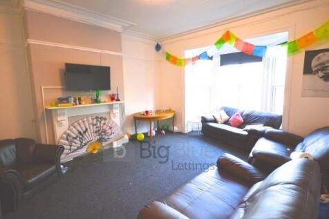 A comfortable living room featuring leather sof...