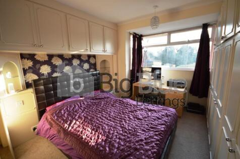 A cozy double bedroom featuring built-in overhe...