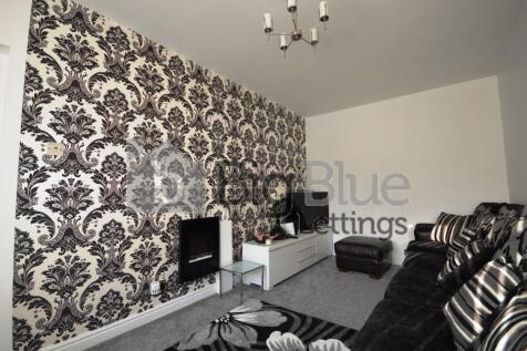 A stylish living room featuring a bold patterne...