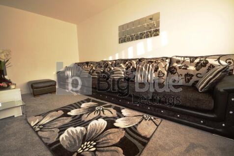 Cozy living room featuring a stylish floral-pat...