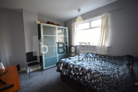 A comfortable double bedroom featuring a large ...