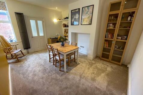 A warm and inviting living room featuring neutr...