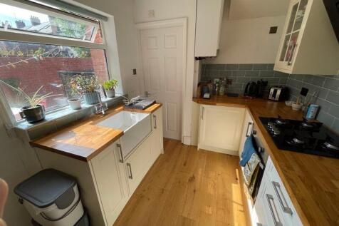Bright and modern kitchen featuring wooden coun...