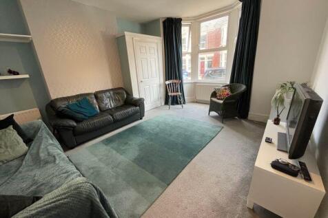 Bright and inviting living room featuring large...