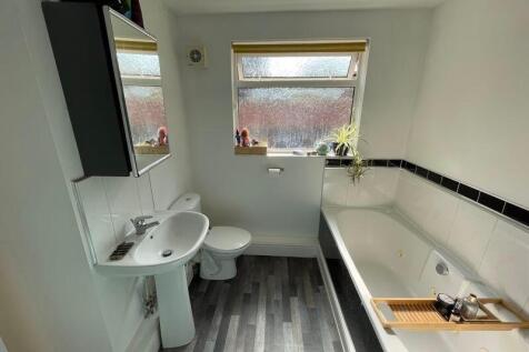 A bright and clean bathroom featuring a large b...