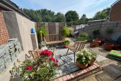 A charming and well-maintained garden featuring...