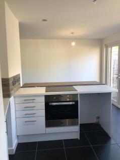 A modern kitchen featuring a sleek built-in ove...