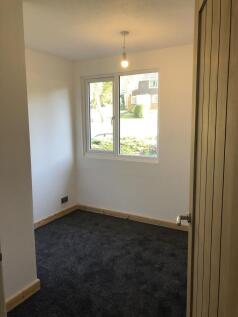 A bright and clean single bedroom featuring a l...