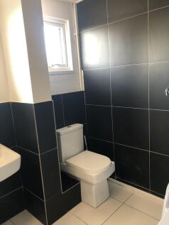 Bright and clean toilet area featuring modern b...