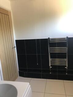 A modern bathroom section featuring sleek black...